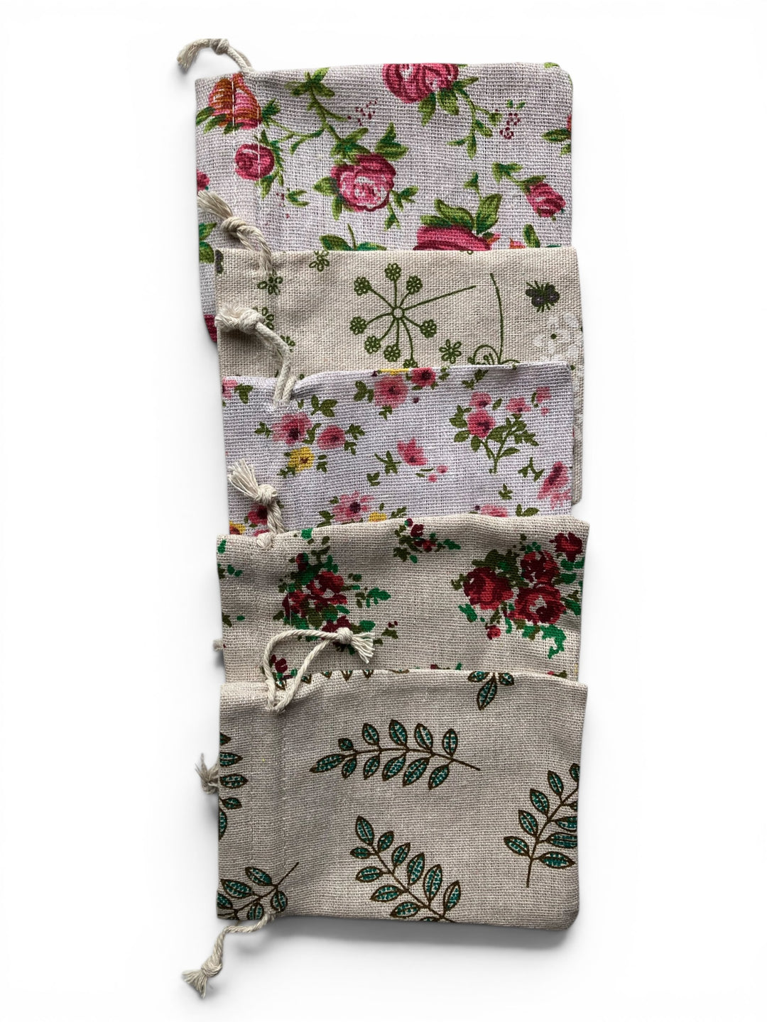 Set of floral and leaf-patterned pouches on a white background