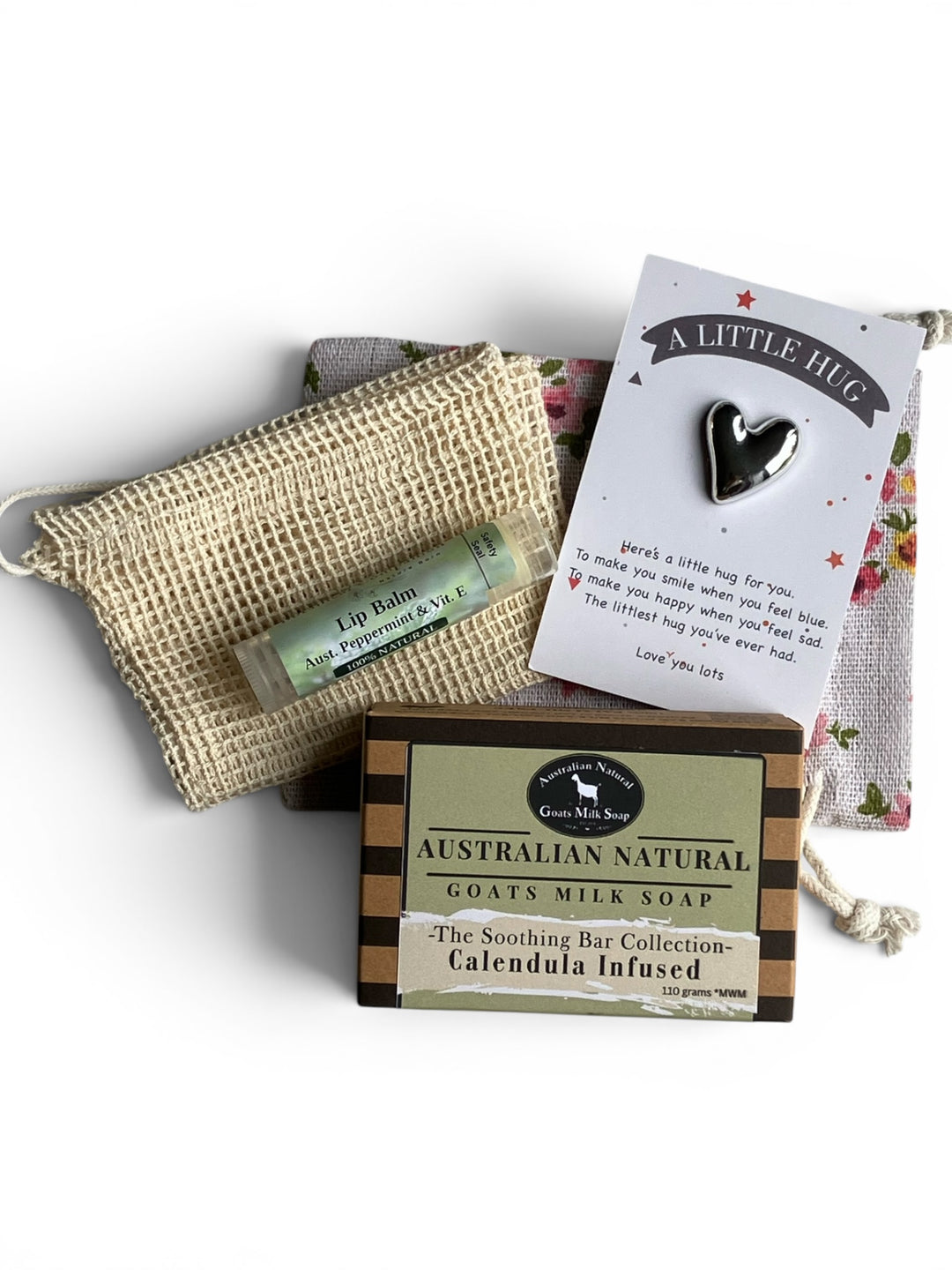Australian Natural Goats Milk Soap with a lip balm, washcloth, and card on a white background