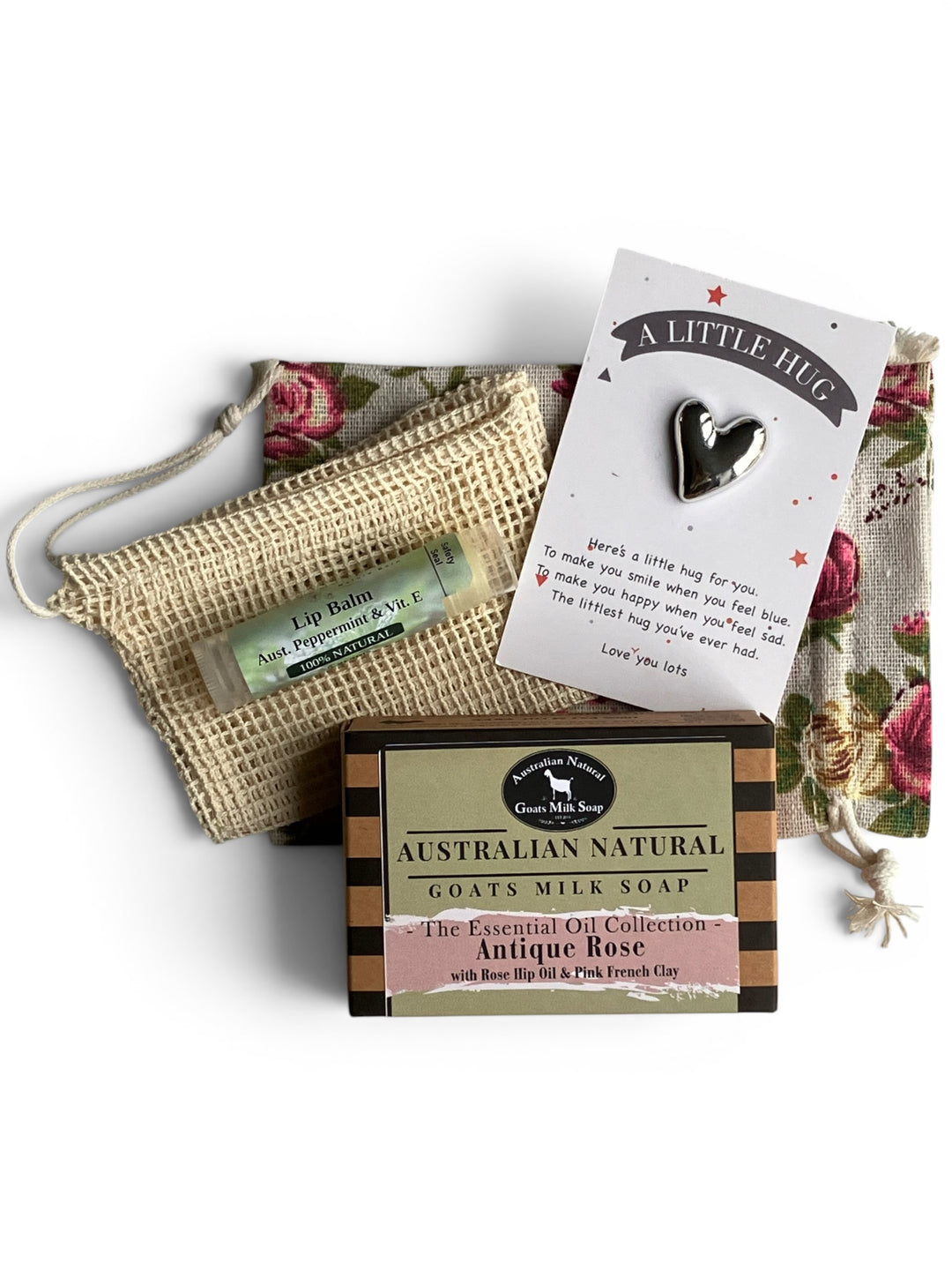 Australian natural goats milk soap with a heart-shaped card, lip balm, and pouch on a white background.
